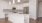 White kitchen with stainless steel appliances and large island